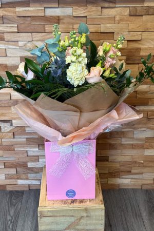 Handtied bouquet of Apricot Rose, Cream Stocks, Apricot Lisianthus, Blue Thistle.