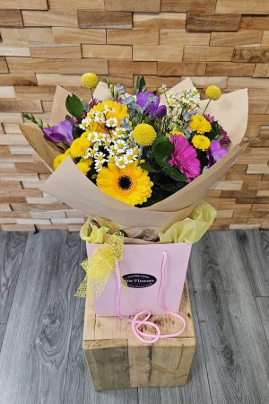 Bright and breezy! Summer Breeze mixes gerbera, crespedia, daisies, freesia, and foliage in water. Hand-tied and locally delivered.
