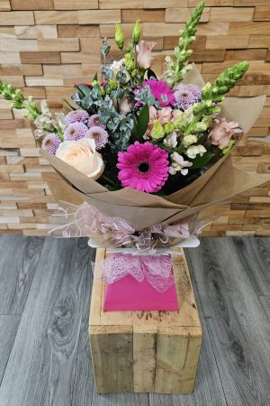 A hand-tied summer bouquet selected by our florists. Fresh, seasonal flowers with colours and blooms varying by availability. Delivered locally.