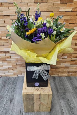 Sunset Meadow is a vibrant mix of delphiniums, lisianthus, gerbera, roses, daisies, and foliage. Hand-tied and locally delivered across Staffordshire.